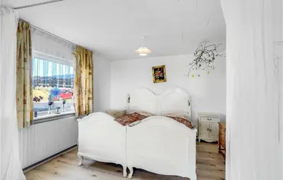 a bedroom with a white bed and a window at Beautiful Home In Nykøbing M With Wifi in Sønder Dråby