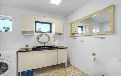 a white bathroom with a sink and a mirror at Beautiful Home In Nykøbing M With Wifi in Sønder Dråby