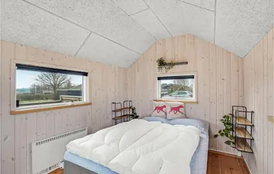 a bedroom with a large bed in a room at 3 Bedroom Nice Home In Hurup Thy in Doverodde