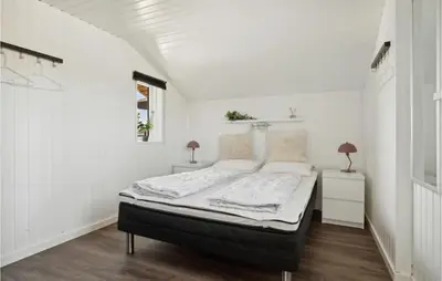 a bedroom with a bed in a white room at 3 Bedroom Nice Home In Hurup Thy in Doverodde