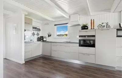 a white kitchen with white cabinets and a window at 3 Bedroom Nice Home In Hurup Thy in Doverodde