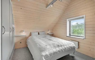 a bedroom with a bed in a room with a window at 1 Bedroom Beautiful Home In Roslev in Roslev