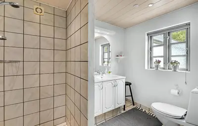 a bathroom with a toilet and a sink at 1 Bedroom Beautiful Home In Roslev in Roslev