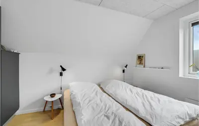a white bedroom with a bed and a window at Stunning Apartment In Thisted With Wifi in Thisted