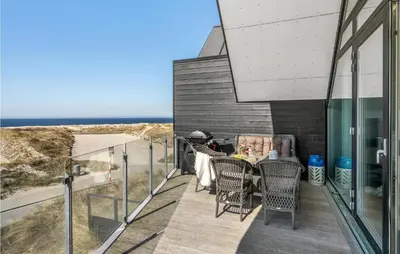 a balcony with a table and chairs and the ocean at Stunning Apartment In Thisted With Wifi in Thisted