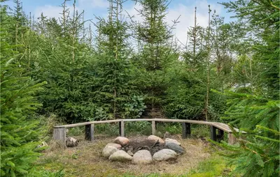 a pile of rocks on a wooden bridge in a forest at Stunning Home In Løgstør With Wifi in Løgstør