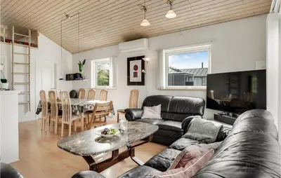 a living room with a couch and a table at Stunning Home In Løgstør With Wifi in Løgstør