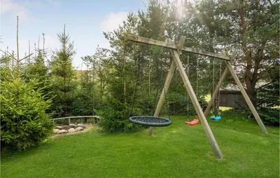 a wooden cross in a yard with a swing at Stunning Home In Løgstør With Wifi in Løgstør