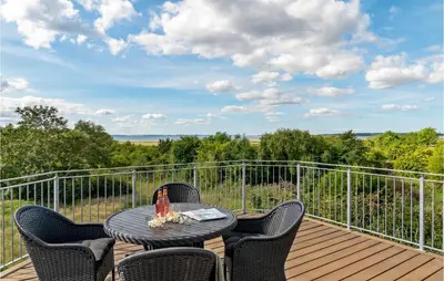 a patio with a table and chairs on a deck at Lovely Home In Aabybro With Kitchen in Åbybro
