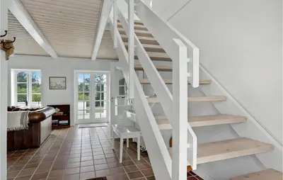 a white staircase in a room with a living room at Lovely Home In Aabybro With Kitchen in Åbybro