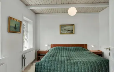 a bedroom with a green bed and a window at Lovely Home In Aabybro With Kitchen in Åbybro
