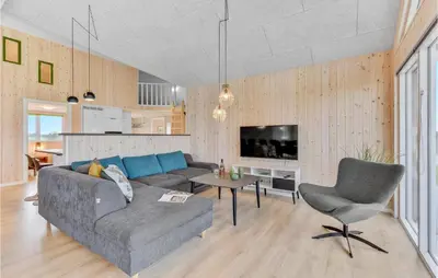 a living room with a couch and a table at Stunning Home In Spøttrup With Sauna in Spottrup