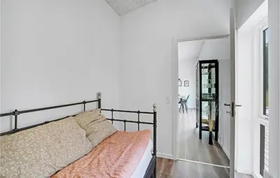 a bedroom with a bed and a hallway with a door at Amazing Home In Spøttrup With Wifi in Spottrup