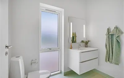 a white bathroom with a toilet and a sink at Amazing Home In Spøttrup With Wifi in Spottrup