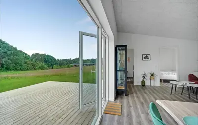 a living room with a large glass door and a table at Amazing Home In Spøttrup With Wifi in Spottrup