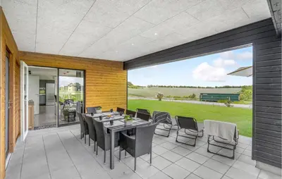 a patio with a table and chairs on it at Gorgeous Home In Løgstrup With Kitchen in Løgstrup
