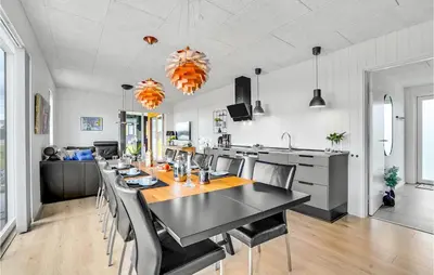 a dining room and kitchen with a black table and chairs at Gorgeous Home In Løgstrup With Kitchen in Løgstrup