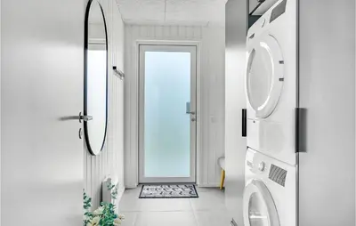 a bathroom with a washing machine and a mirror at Gorgeous Home In Løgstrup With Kitchen in Løgstrup