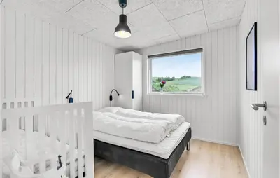a white bedroom with a bed and a window at Gorgeous Home In Løgstrup With Kitchen in Løgstrup