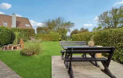 a picnic table and bench in a garden at Amazing Home In Nykøbing M With Wifi in Tæbring