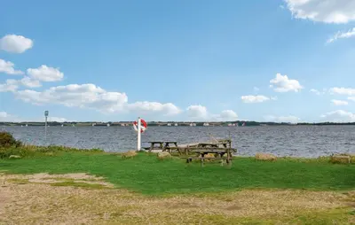 a picnic table next to a body of water at Amazing Home In Nykøbing M With Wifi in Tæbring