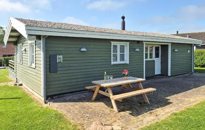 a green caravan with a picnic table in front of it at Stunning Home In Hurup Thy With Wifi in Doverodde