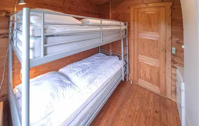 two bunk beds in a cabin with a wooden floor at Stunning Home In Hurup Thy With Wifi in Doverodde