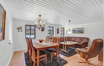 a dining room with a table and a couch at Lovely Home In Hurup Thy With Wifi in Gettrup