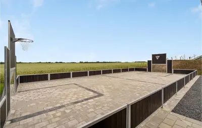 a wooden boardwalk with a basketball hoop and a basketball hoopintend at Cozy Home In Spøttrup With Wifi in Spottrup