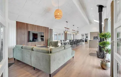 a living room with a couch and a dining room at Cozy Home In Spøttrup With Wifi in Spottrup