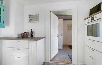 a kitchen with white cabinets and a counter at Nice Home In Bedsted Thy in Bedsted Thy