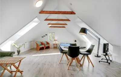 a room with a table and chairs in a attic at Nice Home In Bedsted Thy in Bedsted Thy