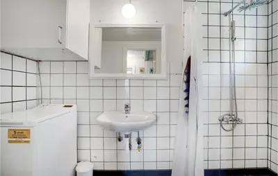 a white bathroom with a sink and a mirror at Nice Home In Bedsted Thy in Bedsted Thy