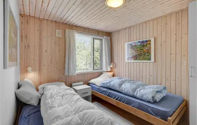 a bedroom with two beds and a window at Awesome Home In Roslev With Kitchen in Roslev