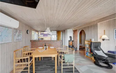 a kitchen and dining room with a table and chairs at Awesome Home In Roslev With Kitchen in Roslev