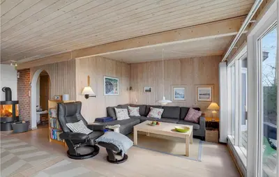 a living room with a couch and a table at Awesome Home In Roslev With Kitchen in Roslev