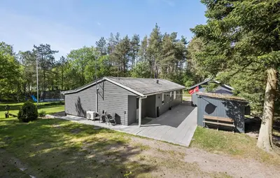 a small shed with a porch and a bench at Amazing Home In Farsø With Wifi in Farsø