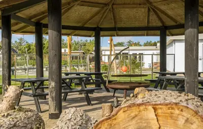 a picnic shelter with picnic tables and a swing at 1 Bedroom Gorgeous Home In Vestervig in Vestervig