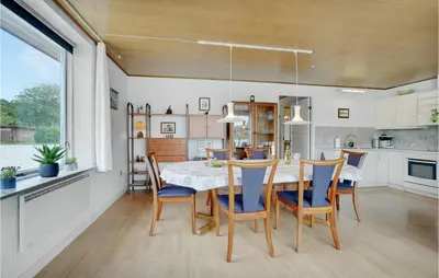 a kitchen and dining room with a table and chairs at 2 Bedroom Awesome Home In Vemb in Vemb