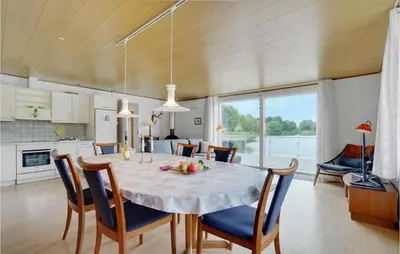 a dining room and kitchen with a table and chairs at 2 Bedroom Awesome Home In Vemb in Vemb