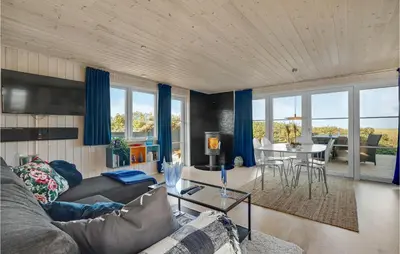 a living room with a couch and a table at Lovely Home In Løgstør With Kitchen in Løgstør