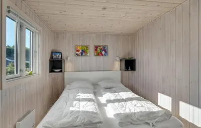 a bedroom with a large bed in the corner at Lovely Home In Løgstør With Kitchen in Løgstør