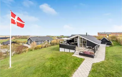 a house with a flag in the yard at Stunning Home In Lemvig With Wifi in Lemvig