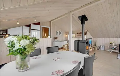 a vase of flowers on a table in a room at Stunning Home In Lemvig With Wifi in Lemvig