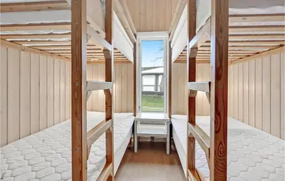 a room with two bunk beds and a window at Lovely Home In Hanstholm With Wifi in Hanstholm