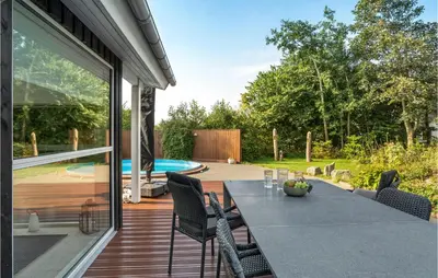a patio with a table and chairs and a pool at Gorgeous Home In Vemb in Vemb