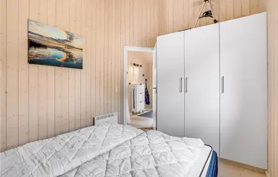 a bedroom with a white bed and a cabinet at Gorgeous Home In Vemb in Vemb