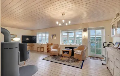 a kitchen and living room with a table and chairs at Nice Home In Thyborøn With Wifi in Thyborøn