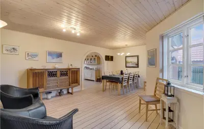 a room with a table and chairs and a dining room at Nice Home In Thyborøn With Wifi in Thyborøn