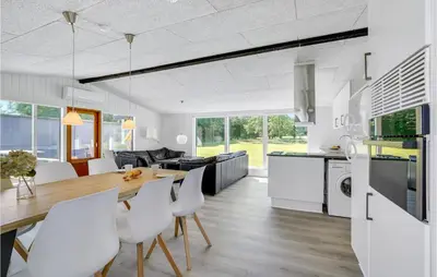 a kitchen and dining room with a table and chairs at 3 Bedroom Lovely Home In Spøttrup in Spottrup